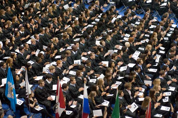 Students sit in McDonough Arena with programs in their hands