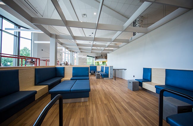 newly renovated dining space features sleek seating with blue fabric and light wood