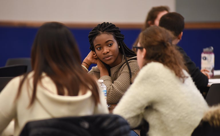 Danielle Maduka sitting and talking with classmates in dialogue session