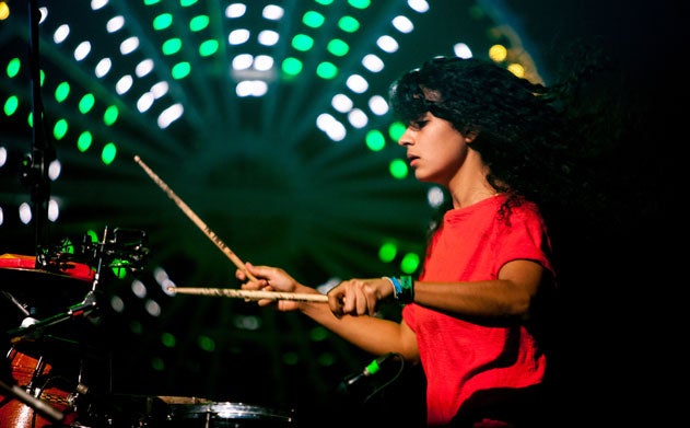 Kiran Gandhi's hair flies as she plays the drums