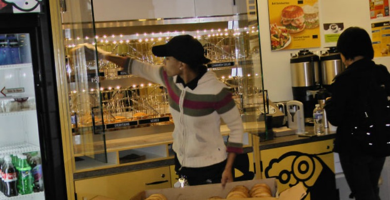 Sheena Brackett stocks fresh bagels at the new Einstein Bros Bagels kiosk located on the second floor of the Car Barn.