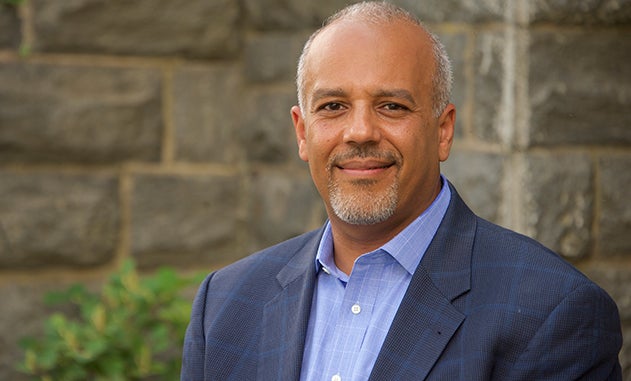 Mo Elleithee smiles for a headshot.