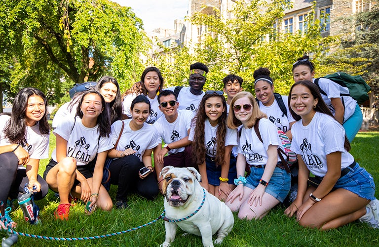 Student who walk Jack the Bulldog on the lawn with the new mascot in training