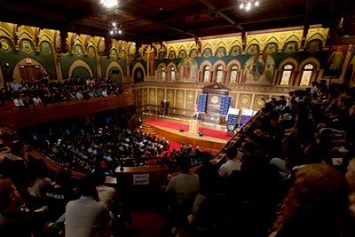 A wide-angle picture of a full Gaston Hall with the audience watching Senator Sanders speak from a podium.