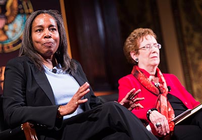 Valerie Babb and Kathleen Lesko, seated onstage at Gaston Hall, make discuss with other panel members.