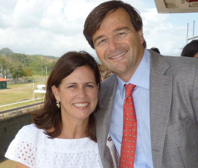 Alberto and Olga Maria Beeck stand under an awning 