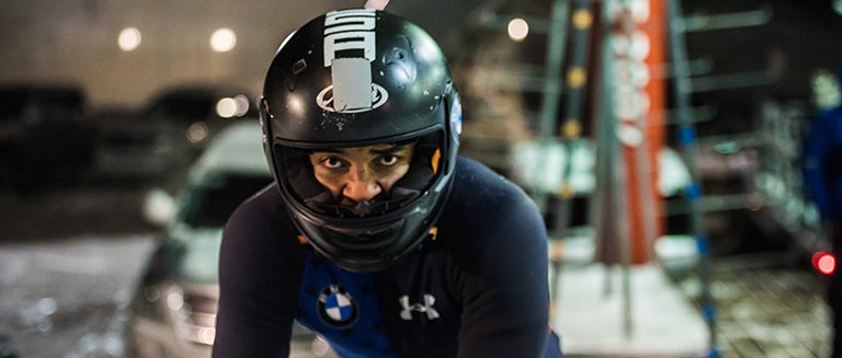 Christopher Kinney stares ahead outfitted in his bobsledding gear