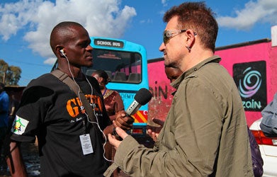 Bono speaks with Abraham Mariita, station manager at 99.9 Ghetto FM, the community radio station in the Kibera area of Nairobi, Kenya, in 2010. Photo by ONE.