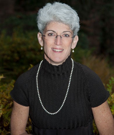 Lisa Brown smiles at the camera for a headshot.