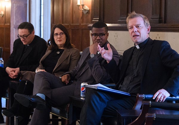 Rev. Bryant Oskvig, Rabbi Rachel Gartner, Rev. Brandon Harris, Rev. Greg Schenden talk on stage during a panel discussion.