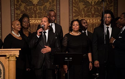 A choir sings in Gaston Hall during the ceremony