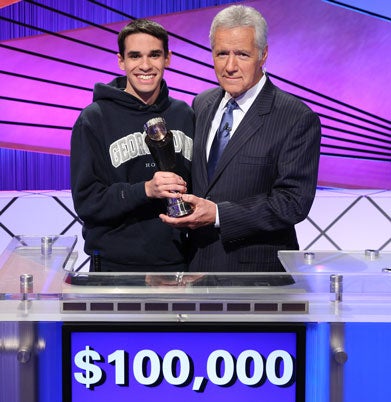 Jim Coury holds trophy with Alex Trebek on set of Jeopardy!