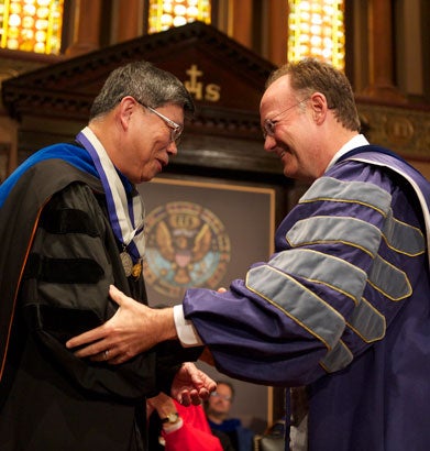 Der-Chen Chang shakes hands with John J. DeGioia in Gaston Hall