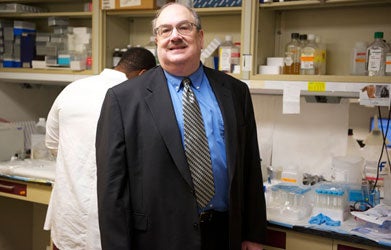 Dr. Eliot Rosen smiles in a lab. 