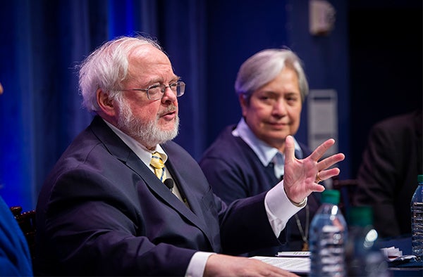 John Carr speaks while Norma Pimentel looks his way while sitting next to him.