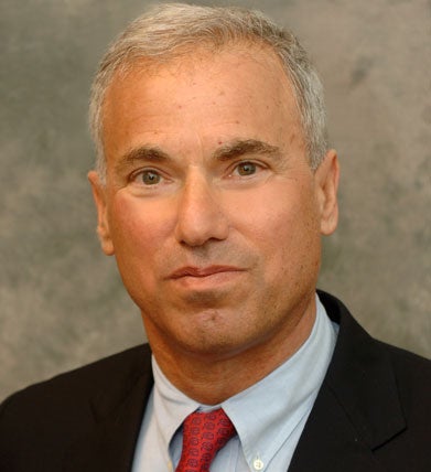 Dr. Jesse L. Goodman, dressed in a suit and tie, smiles in a headshot.