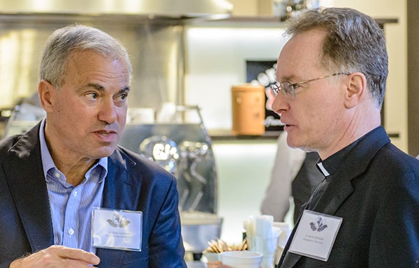 Dr. Jesse Goodman and Kevin FitzGerald, S.J. talk during the workshop 