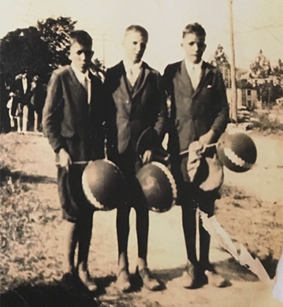 Abraham, Issac and Jacob Mills standing and holding balloons