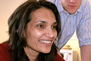 Chandan Vaidya sitting with student standing over her