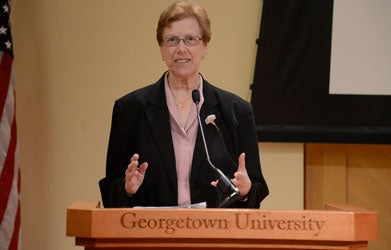 Susan Martin speaks at a podium in Lohrfink Auditorium