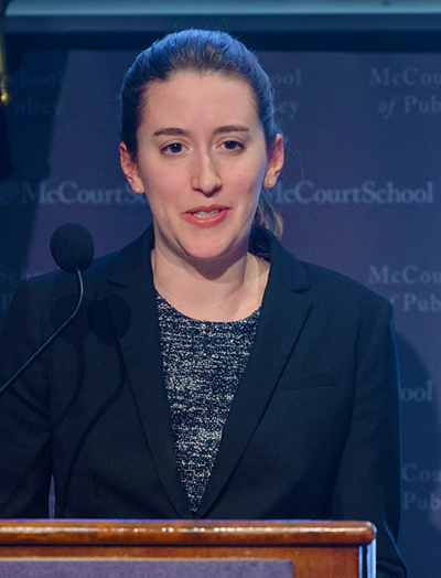 McCourt School of Public Policy student Rachael Kauss speaks into the microphone while standing at the lectern.