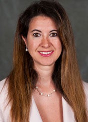 Adriana Kugler smiles in a headshot. 