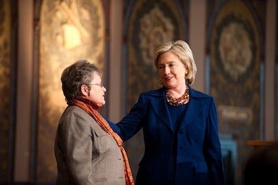 Dean Lancaster with Hillary Clinton on Gaston Hall's stage.