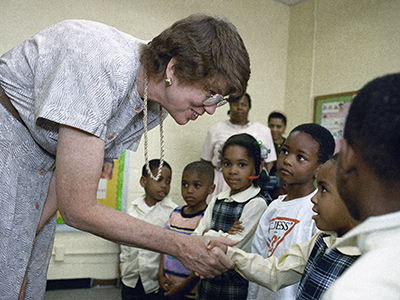 Janet Reno shaking hands with children