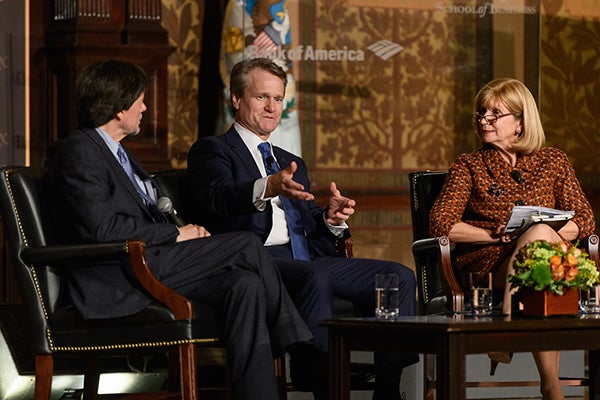 Ken Burns, Brian Moynihan and Paula Dobriansky sitting onstage in Gaston Hall