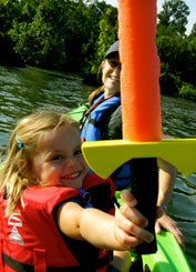 Maggie Smith and her daughter Emily play with a toy at a lake.