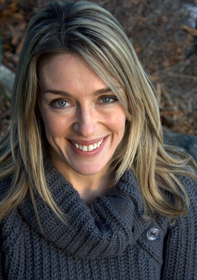 Psychology professor Abigail Marsh, wearing a gray knit sweater, smiles up at the camera.