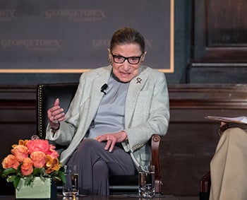 Ruth Bader Ginsburg sitting, talking to audience