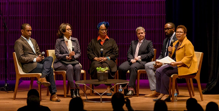 Rodney Leon, Gayle Jessup White, Melisánde Short-Colomb, Sharon Leon and Elgin Cleckley listen on stage while seated as Michel Martin talks to the audience.