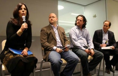 Georgetown alumnus Jim McCormick (C'90) listens as Liz Leahy (C'91) speaks during a panel discussion.