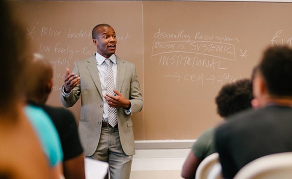 Professor Robert Patterson stands in front of his class teaching 