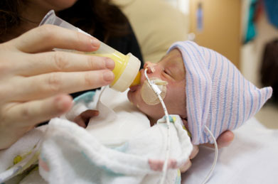 Premature baby is fed in a hospital