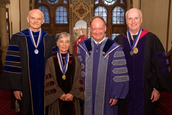 President John J. DeGioia stands with Distinguished Scholar-Teacher honorees Darlene Howard, Donald Langevoort and Dr. Anton Wellstein all dressed in academic regalia