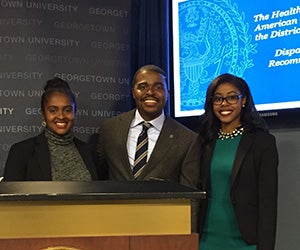 Christopher King, an assistant professor at the university’s School of Nursing & Health Studies (NHS) poses for a photo with two student report contributors, Stefanie Kurgatt (NHS'17) and Taylor Brown (NHS'17).