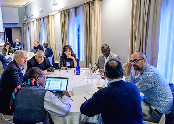 Georgetown's Medical Center faculty members sit around a table with other faith-based experts to discuss antimicrobial resistance 