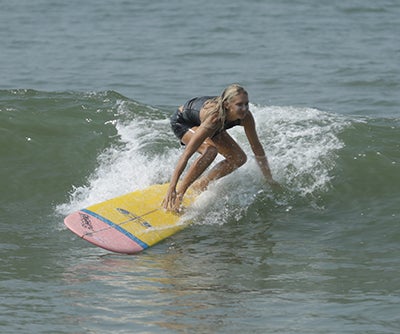 Emi Koch surfing in the ocean