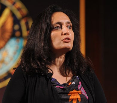 Sonal Shah speaks in front of the Georgetown University seal