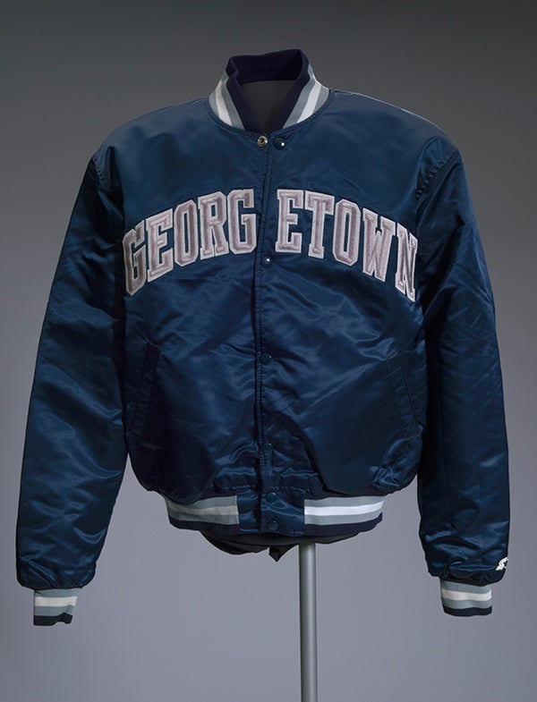 An athletic Starter jacket with Georgetown across it appears on display.