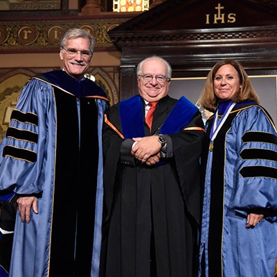 Provost Robert Groves and Janet Mann present John Tutino with an award for research achievement.