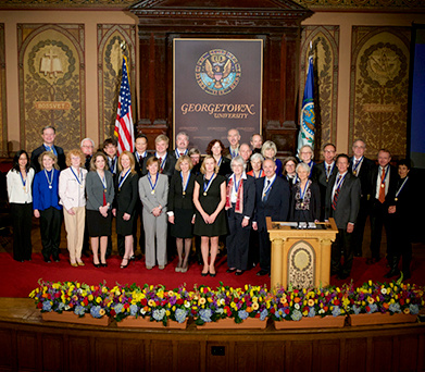 2015 Vicennialist Medalists stand on stage in Gaston Hall