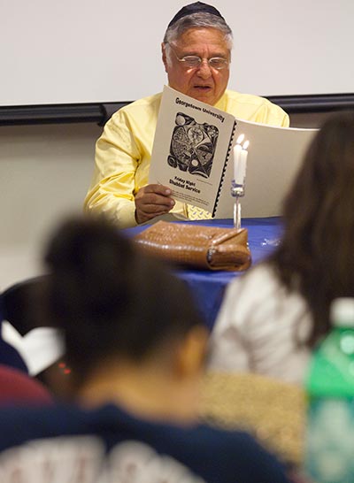 The late Rabbi Harold White, who was the first full-time Jewish chaplain at a U.S. Catholic university and helped develop Georgetown’s Jewish civilization program, leads a traditional Shabbat service on campus.