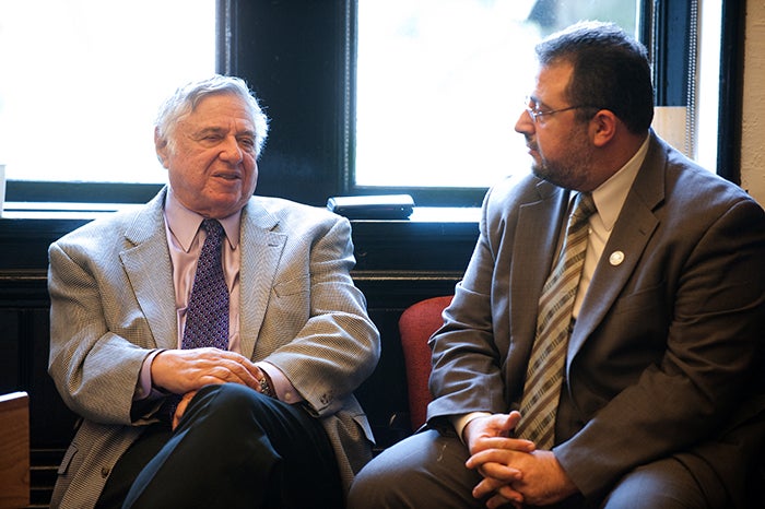 Rabbi Harold White sits as part of a panel discussion in Riggs Library at Georgetown.