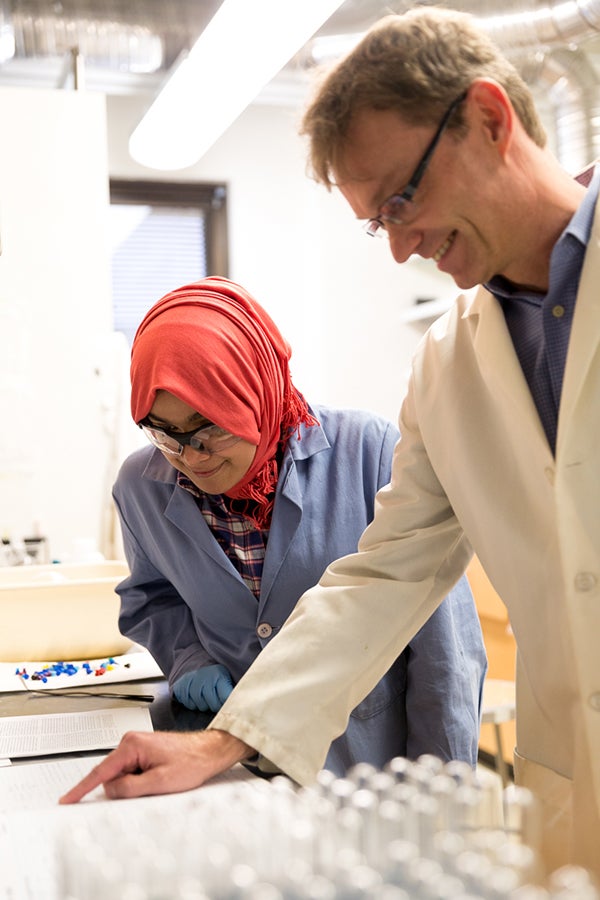 Christian Wolf works with a student in his lab.