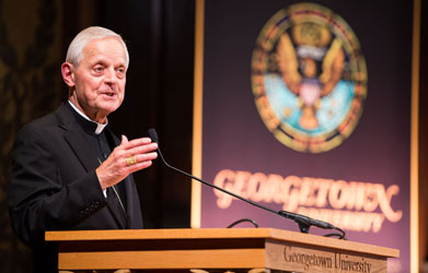 Cardinal Donald Wuerl, Archbishop of Washington, addresses the audience from a podium in Gaston Hall.