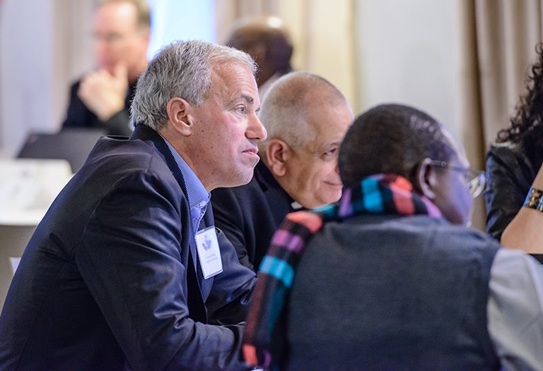 r. Jesse Goodman listens as workshop participants talk