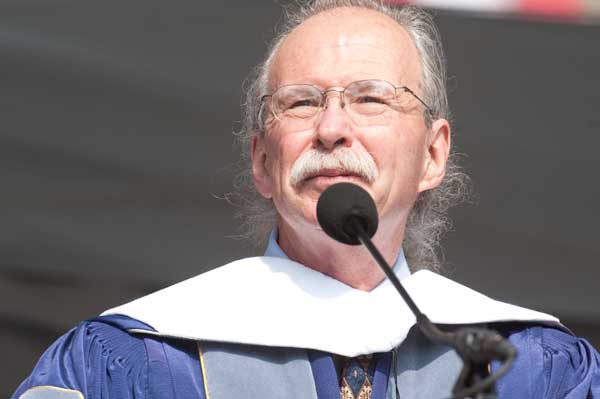 Richard White looks out at the audience while speaking into a microphone
